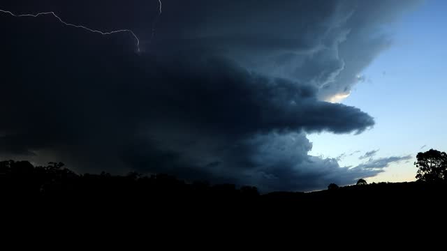 Lightning striking beneath a dusk storm